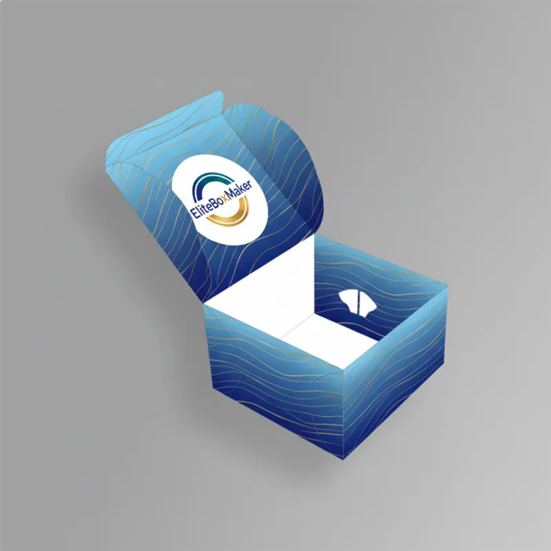 A light brown, open paperboard cake box with self-locking tabs is viewed from above, revealing the empty interior.